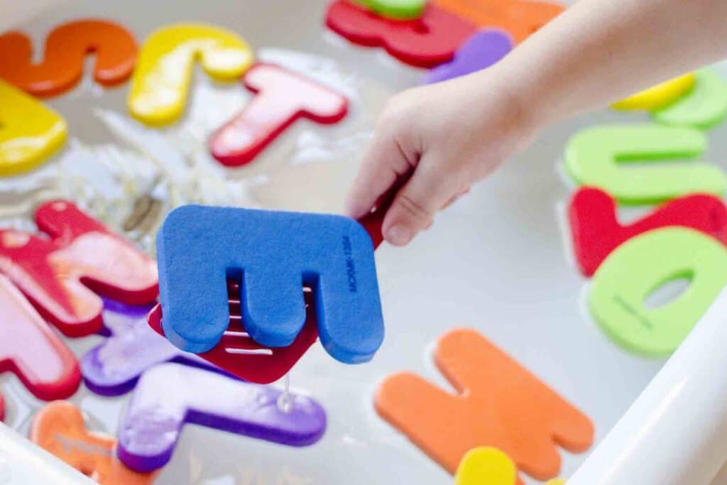 Toddler activities using letters floating in water | The Dating Divas