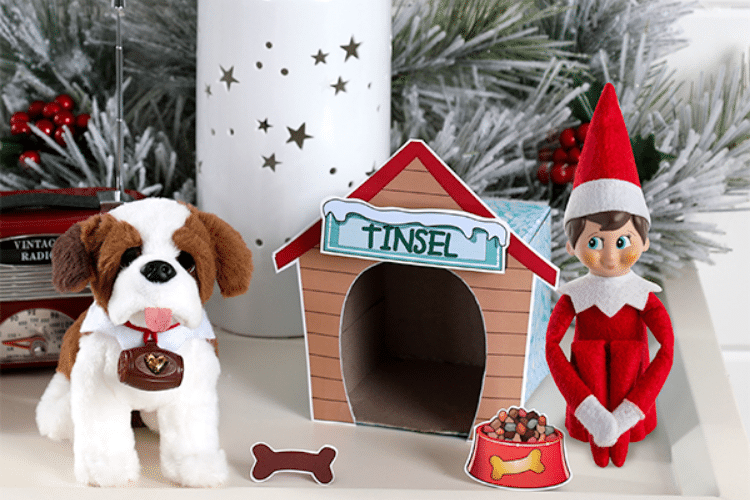 Elf on the shelf sitting with dog toy outside doghouse | The Dating Divas