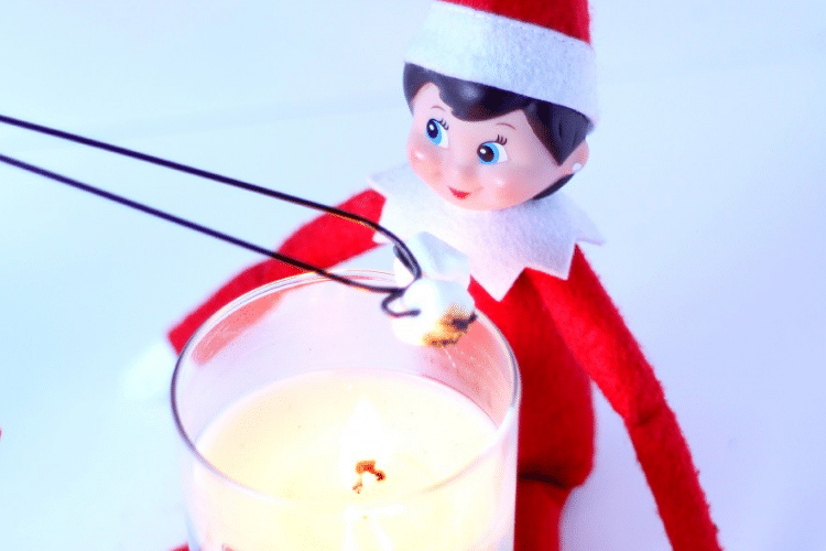 Elf on the shelf roasts s'mores by candlelight | The Dating Divas