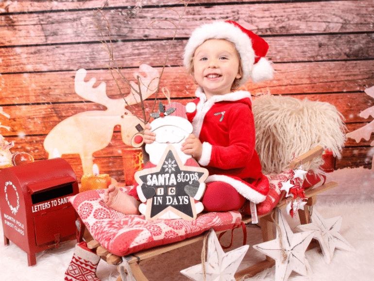 Family Christmas pictures that have a young child on a sleigh | The Dating Divas