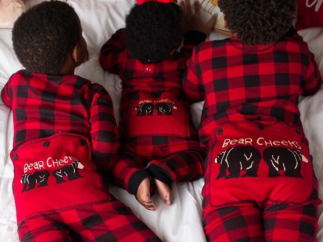 Christmas card ideas that show three siblings wearing magic Christmas pajamas | The Dating Divas