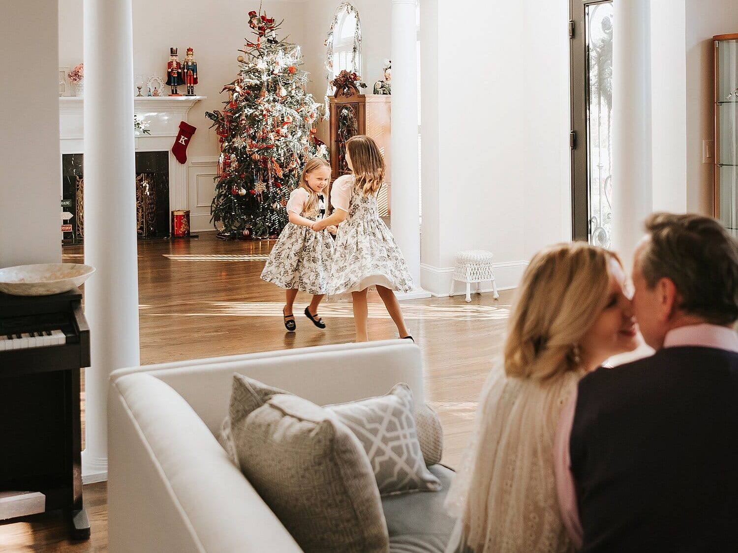 Family Christmas cards ideas showing sisters dancing in front of the tree | The Dating Divas