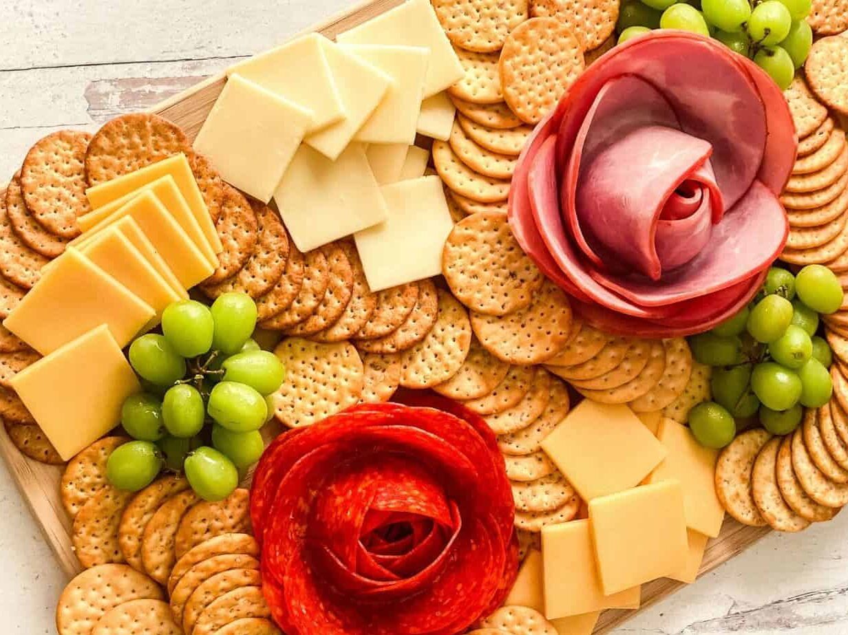 Fancy charcuterie board with meat flowers for easy dinner ideas for two | The Dating Divas