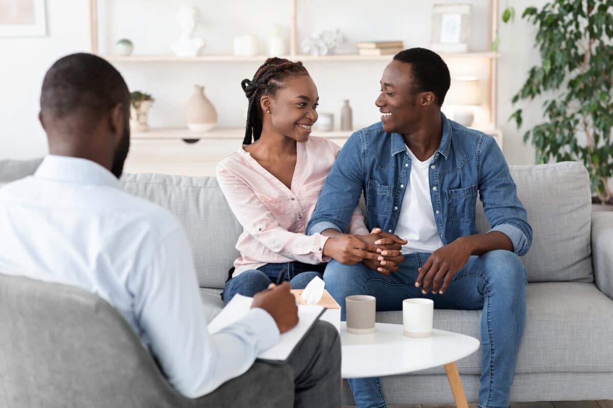 A couple smiling in couple counseling  Dating divas