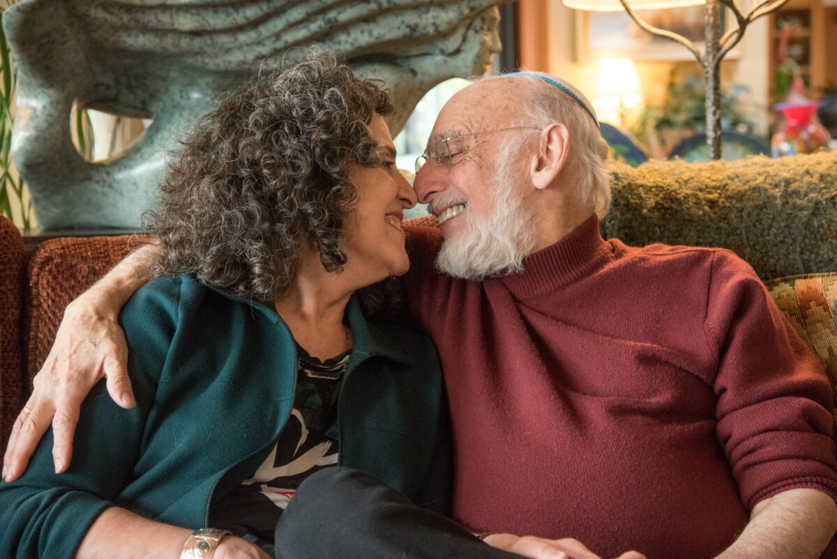 World renowned marriage advice and relationship researchers Drs John and Julie Gottman nuzzle affectionately | The Dating Divas