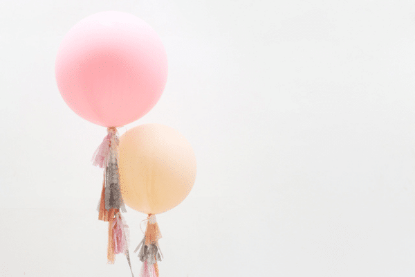 Round balloons with fringe attached to bottom | The Dating Divas