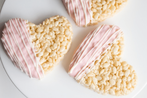 Heart-shaped rice krispie treats dipped in chocolate | The Dating Divas