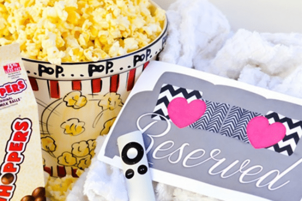 Romantic Valentine's Day ideas: candy, popcorn, and loveseat lounge invitation | The Dating Divas