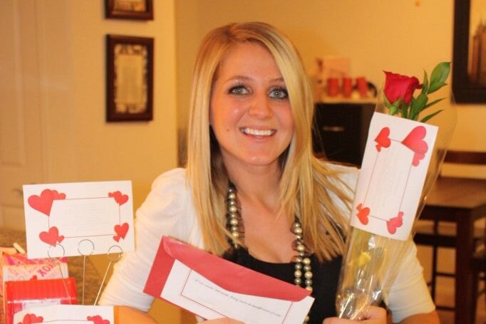 A woman holding a romantic Valentine's Day idea made by her husband | The Dating Divas