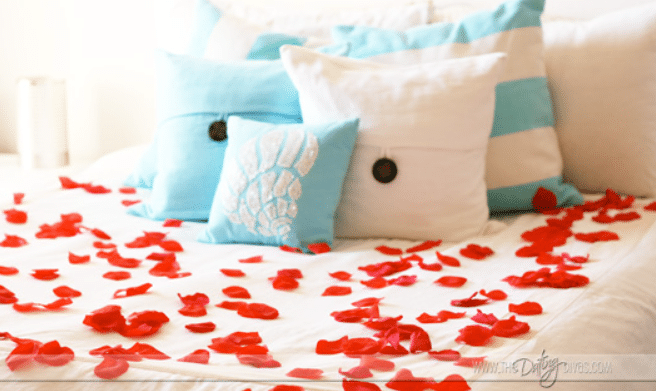 Spice up your Valentine's Day ideas with rose petals on the bed! Instant romance! | The Dating Divas 