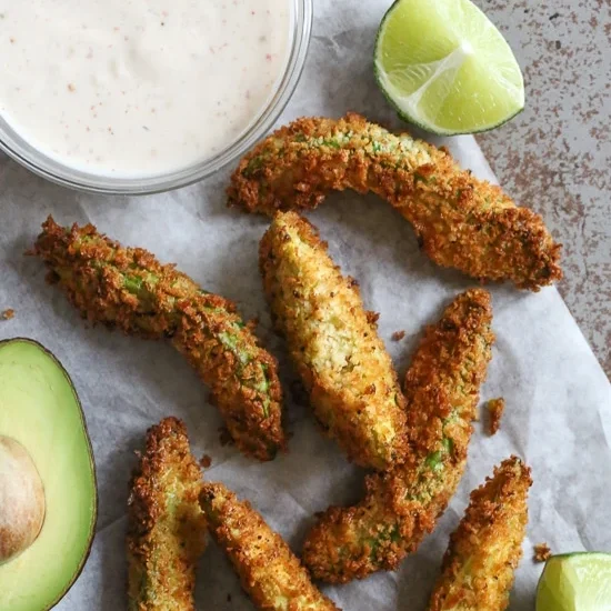 Delicious avocado fries and dipping sauce. The perfect savory snack to serve at your St. Patrick's Day party! | The Dating Divas