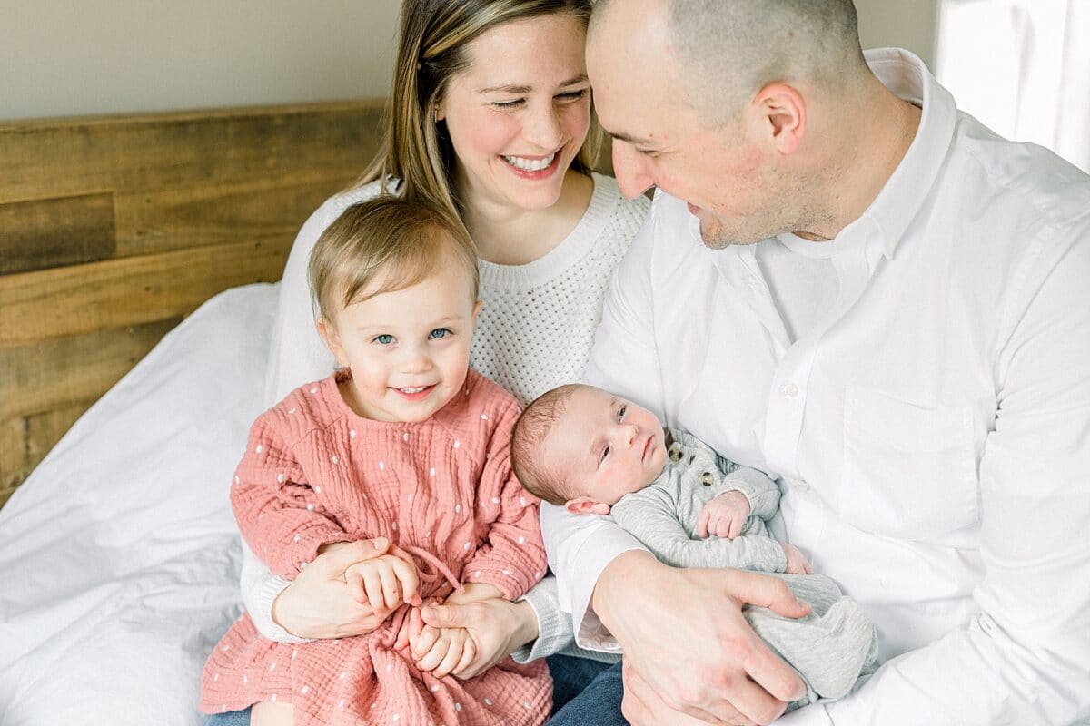 Try a cozy family pose at home for your newborn photography session | The Dating Divas