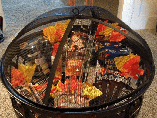 Perfect Easter basket for men idea with roasting sticks and treats inside an outdoor fire pit | The Dating Divas