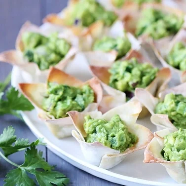 Green, delicious guacamole cups are the perfect St. Patrick's Day party food. | The Dating Divas