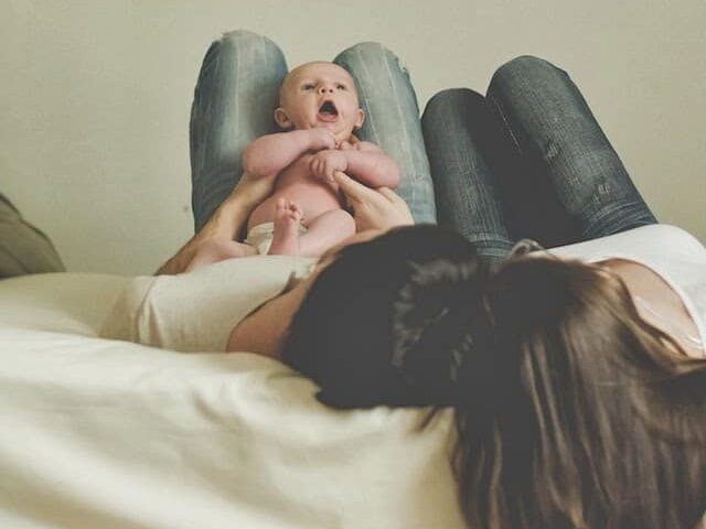 Place baby on your lap and take a photo from above in these unique newborn baby pictures | The Dating Divas