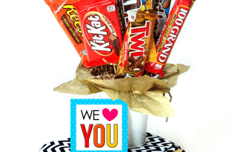Valentine's day gift idea candy bar bouquet with "We love you" sign in front of it | The Dating Divas