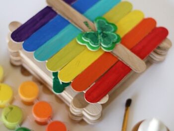 A leprechaun trap made of rainbow painted popsicle sticks | The Dating Divas