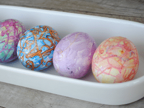 Melt crayons on hot, hard boiled eggs for beautiful Easter egg designs. | The Dating Divas