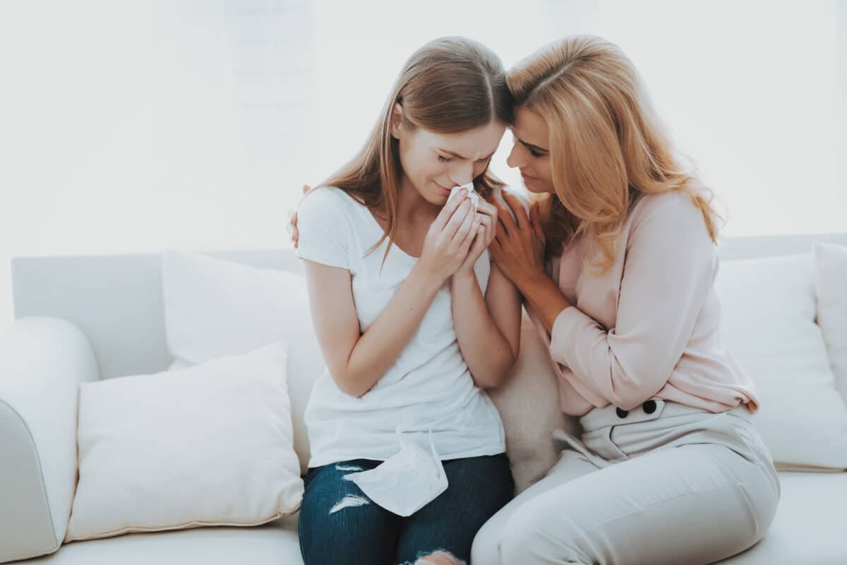 Mother comforts her crying teenager in an example of good parenting | The Dating Divas
