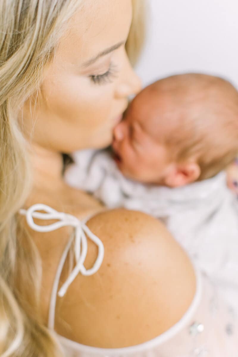 A photo of a newborn baby held over a mother's shoulder. | The Dating Divas