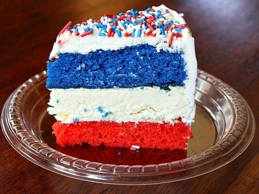 Stacked red, white, and blue 4th of July cheesecake cake recipe. | The Dating Divas