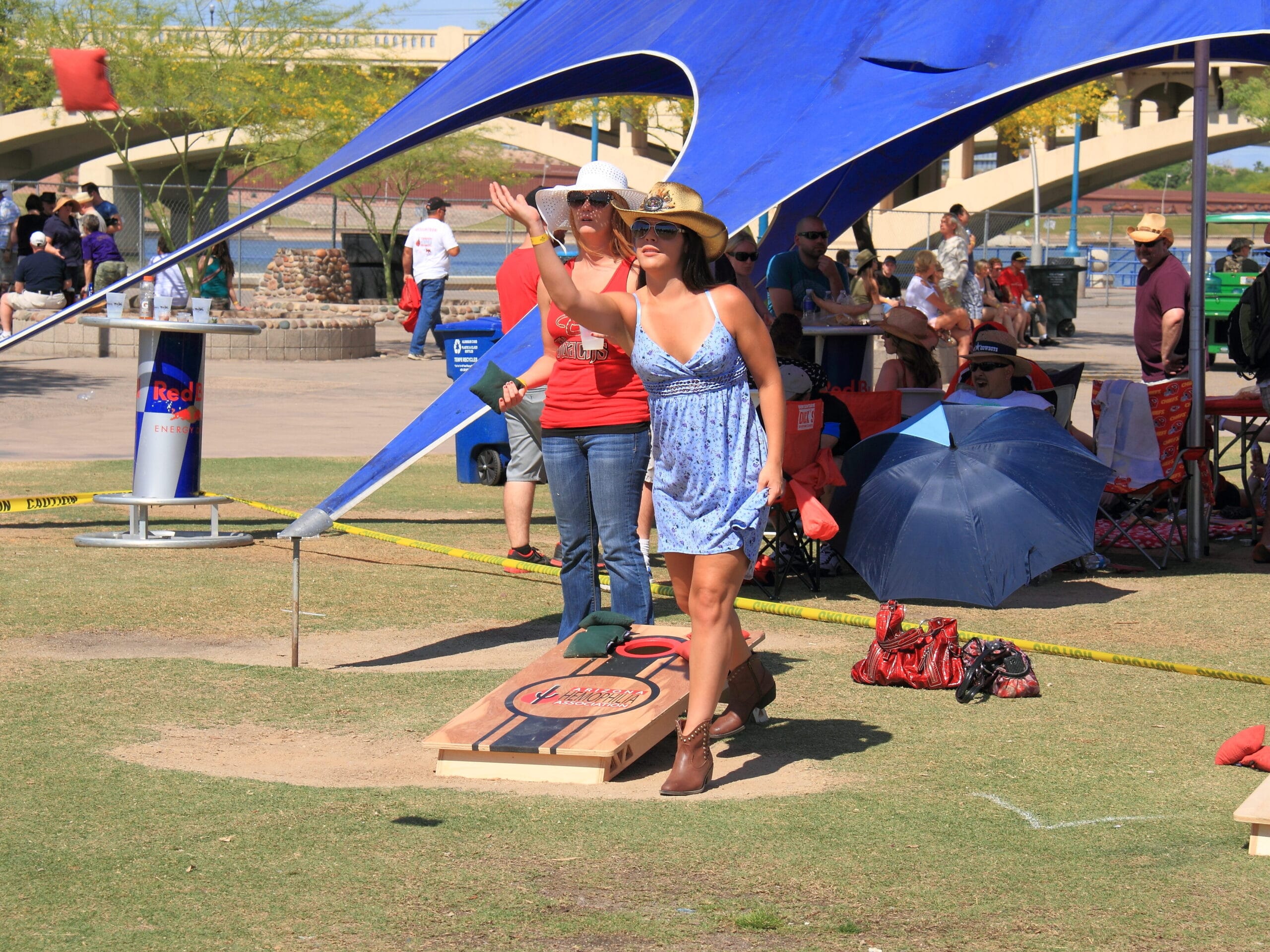 Couple plays bean bag toss at a family get together. | The Dating Divas