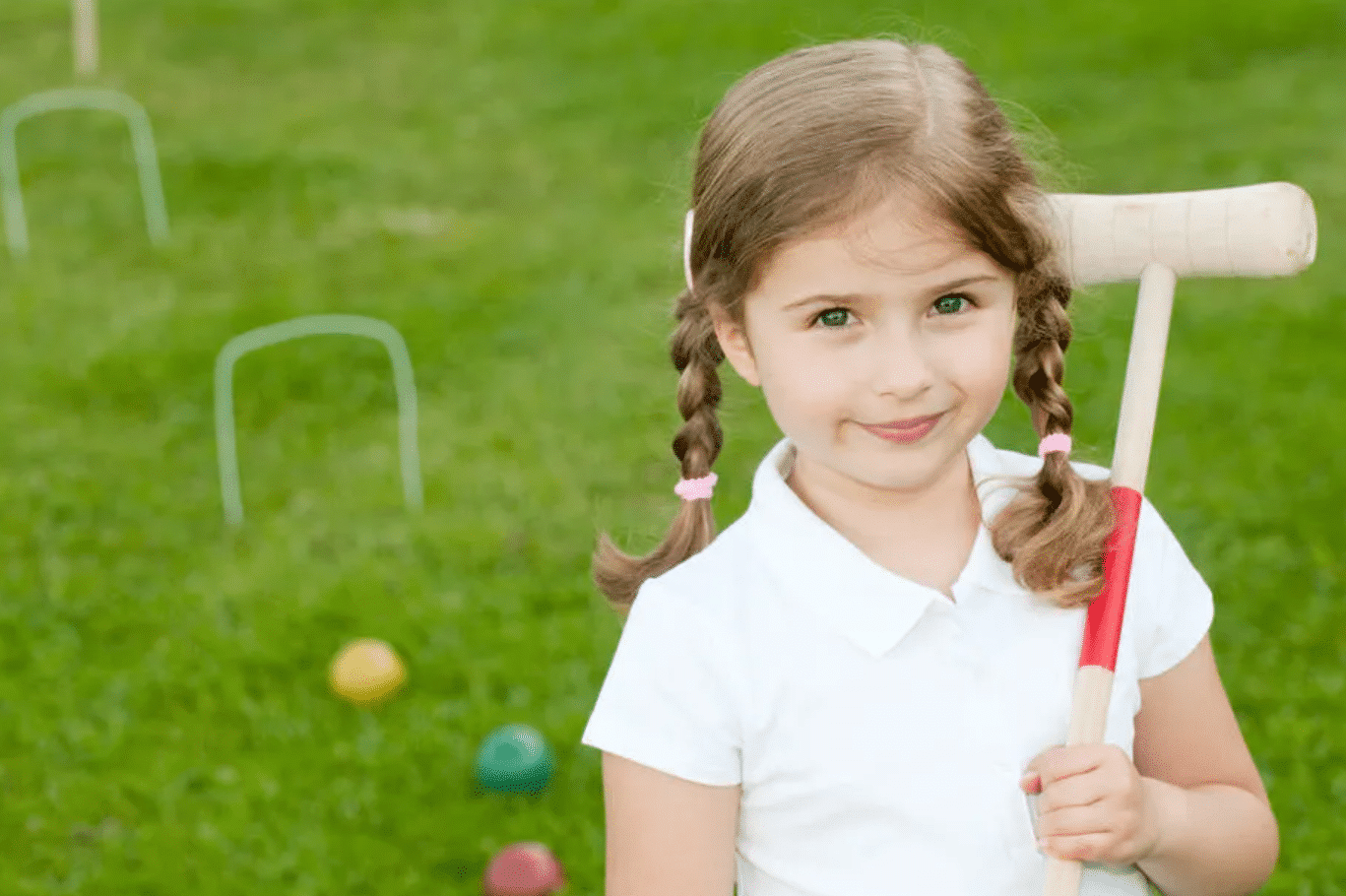 A child playing an outdoor game of croquet | The Dating Divas