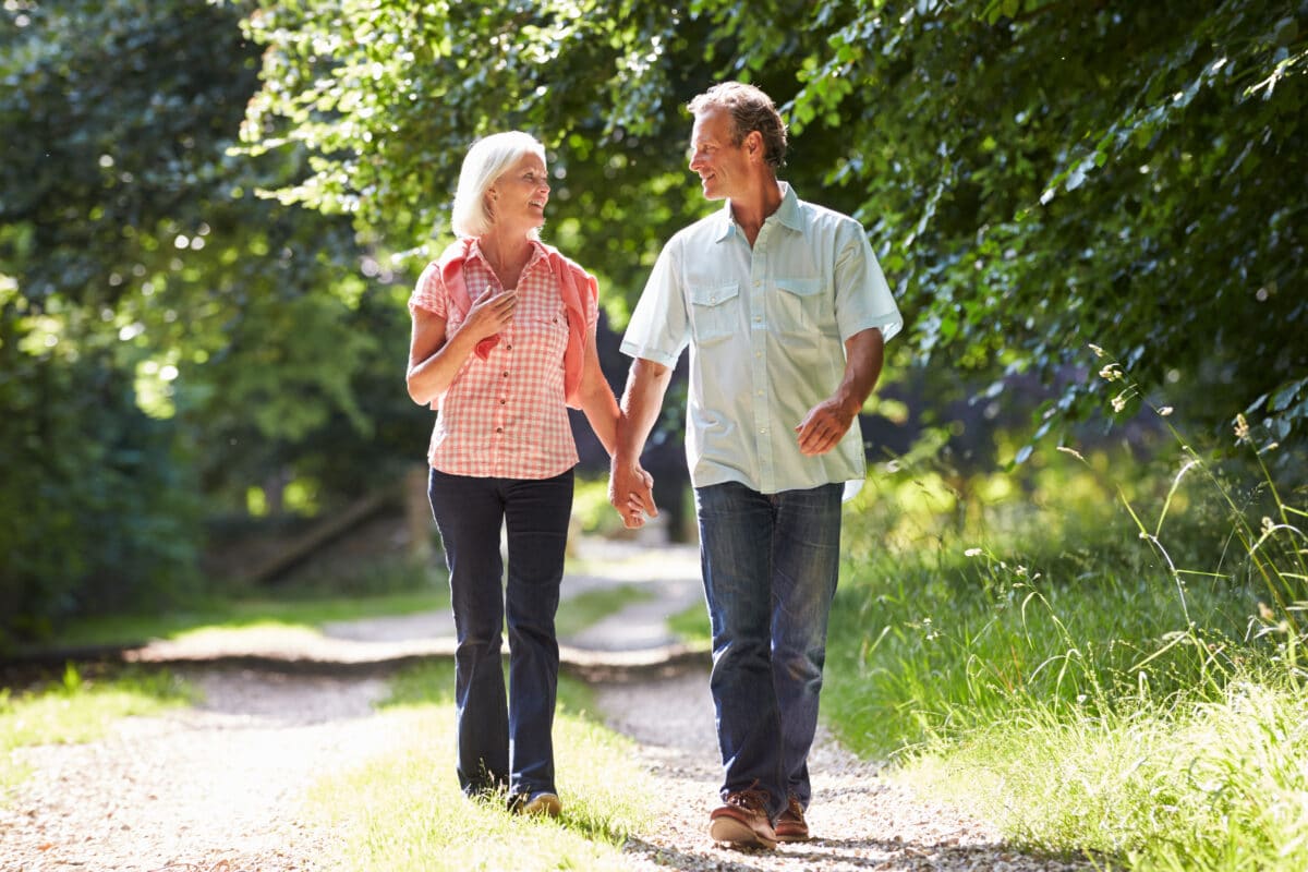 A man and woman on an afternoon walk while battling empty nest syndrome | The Dating Divas