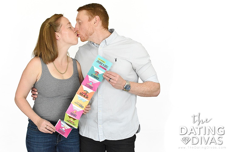A man and woman enjoying a gift card accordion book | The Dating Divas