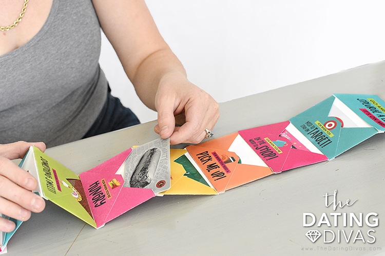 A woman assembling a gift card holder with free printable envelopes | The Dating Divas