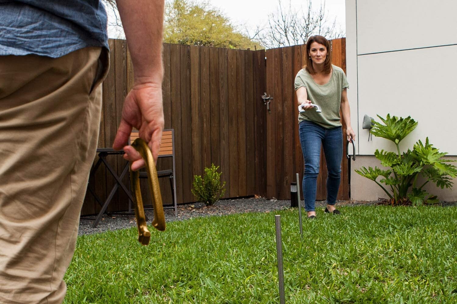 A man and woman playing an outdoor game of Horseshoes | The Dating Divas