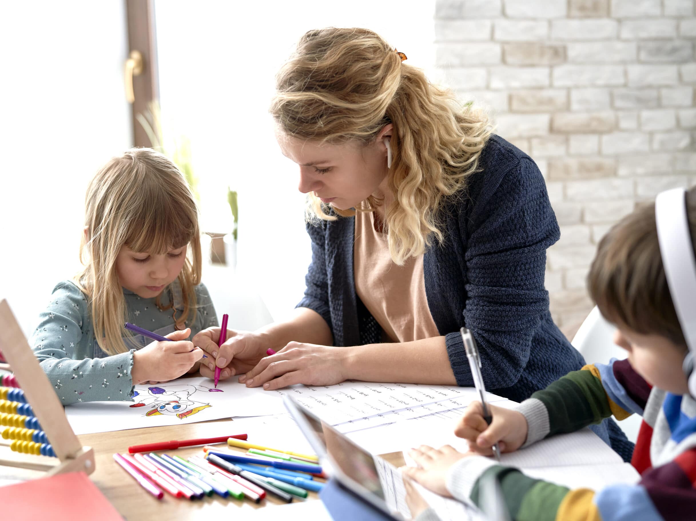 Homeschooling mom helping her kids with their home based-learning. | The Dating Divas