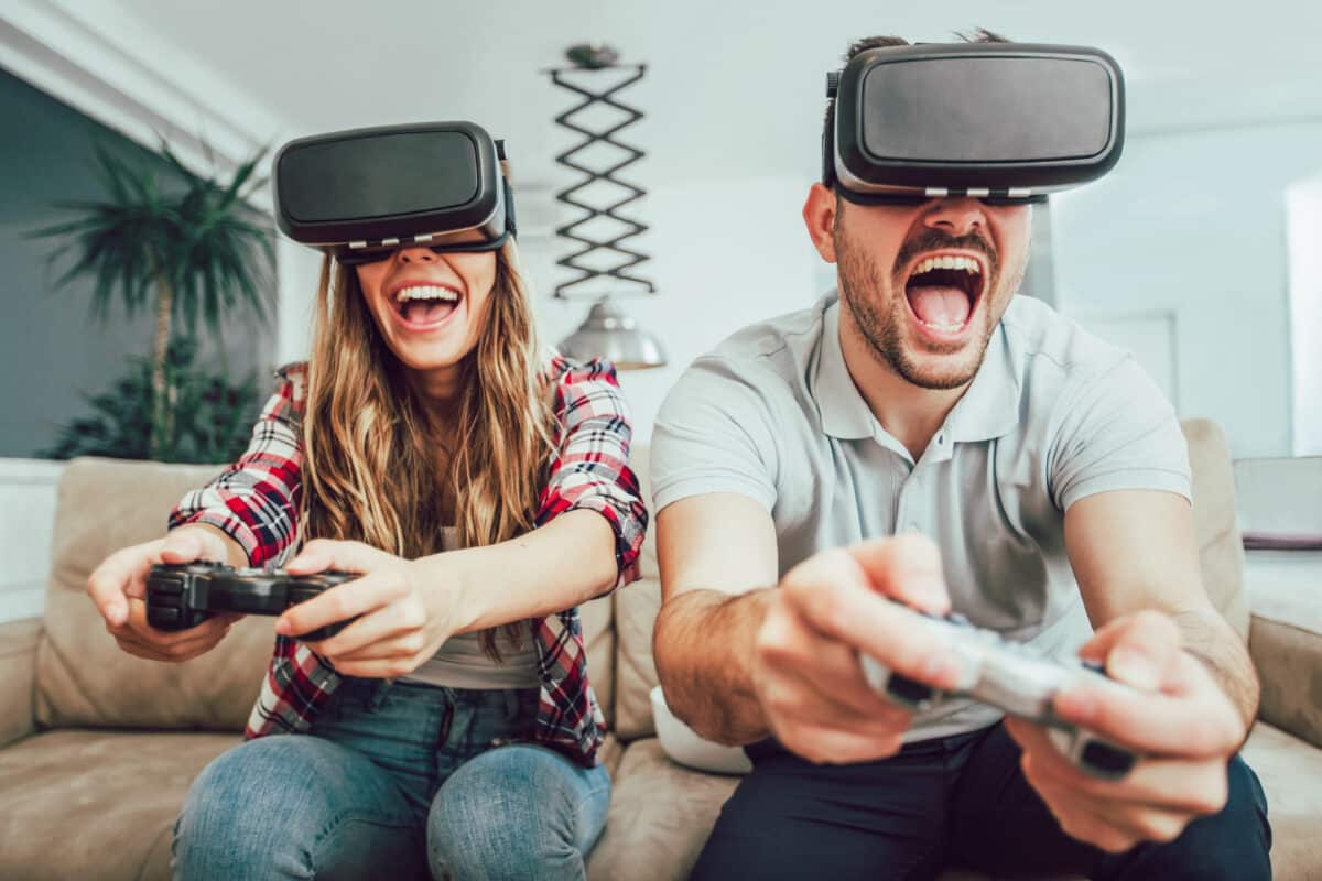 A man and woman playing a virtual reality game and testing out fun date night ideas for gamers | The Dating Divas