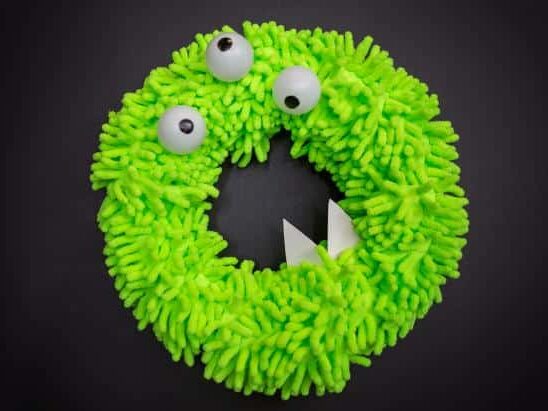 Make this fuzzy monster wreath for fun DIY Halloween decorations! | The Dating Divas