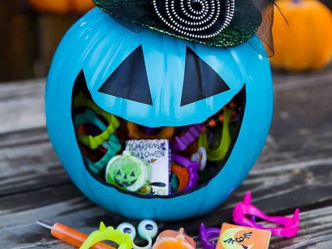 Make a candy holder out of a plastic pumpkin for DIY outdoor Halloween decorations for trick-or-treating. | The Dating Divas