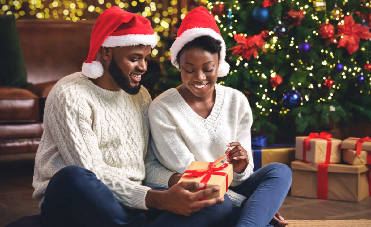 Husband and wife opening Christmas presents together to fight off homesick feelings | The Dating Divas