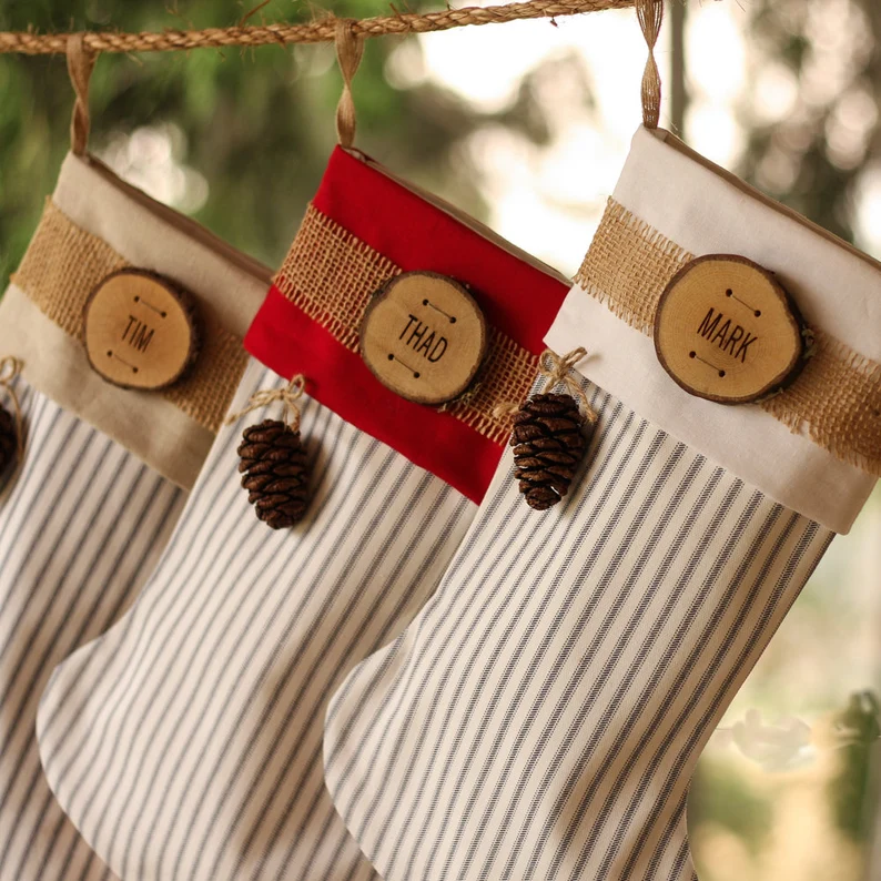 Get outdoorsy, rustic vibes with these striped personalized Christmas stockings. | The Dating Divas