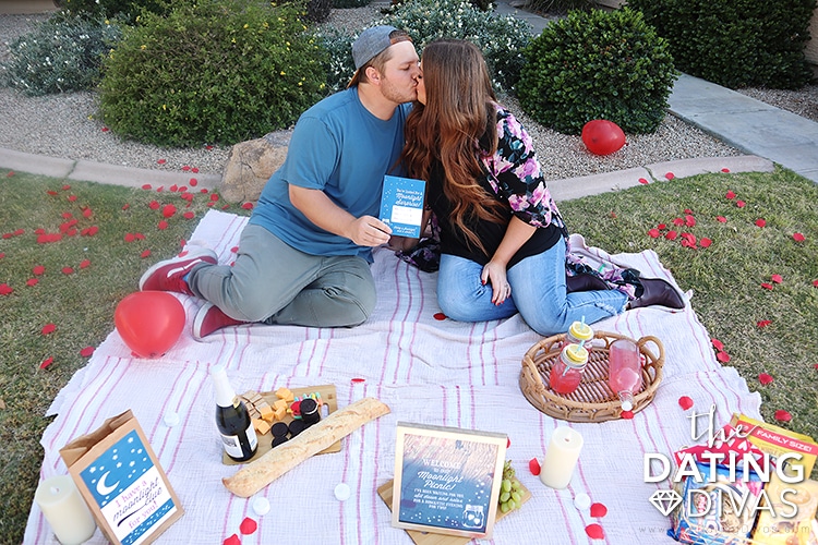 A couple kissing while doing a romantic scavenger hunt | The Dating Divas