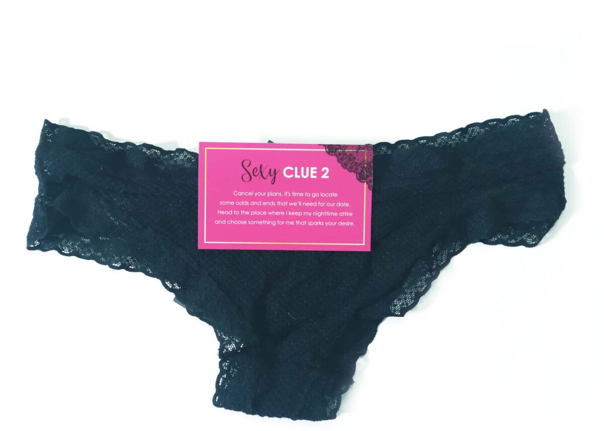 A piece of lingerie with a scavenger hunt idea card lying on top | The Dating Divas