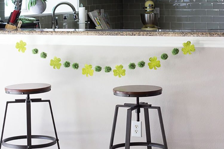 St. Patrick's Day decor can be a quick DIY project with green yarn and dollar store shamrocks. | The Dating Divas