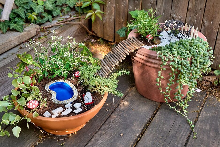 Try making this unique fairy garden with a bridge between two pots. | The Dating Divas