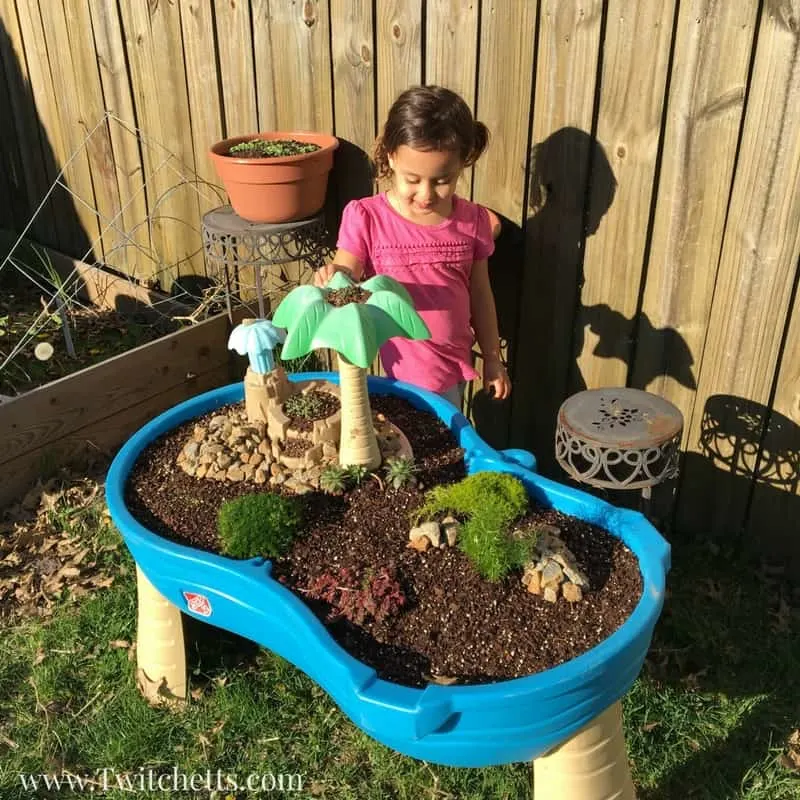 Repurpose an old water table into a magical fairy garden for your children. | The Dating Divas