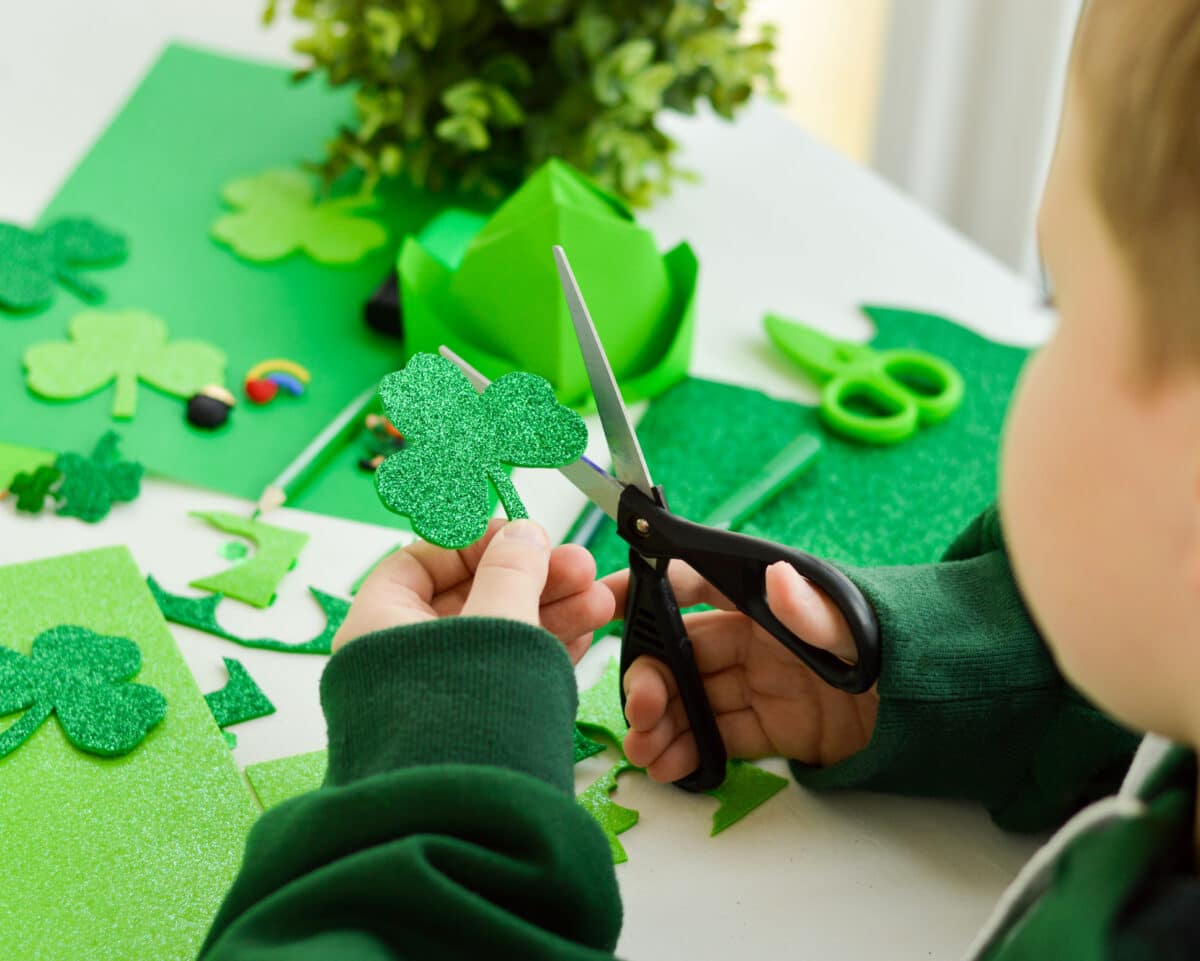 Boy enjoys cutting out a St. Patrick's Day craft | The Dating Divas