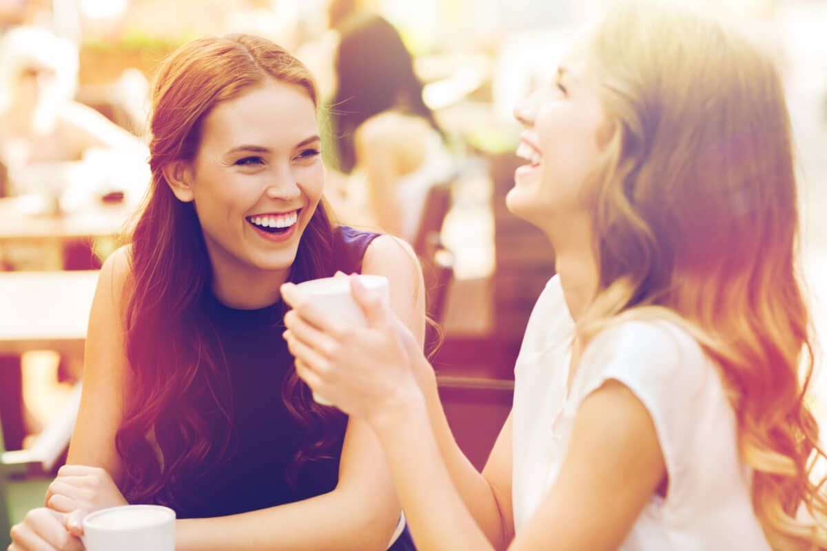 Two women laugh while enjoying their friendship. | The Dating Divas
