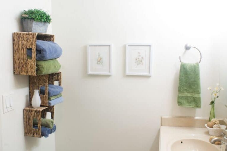 Are you looking for unique DIY home decor ideas? Put storage baskets on your bathroom wall for towels. | The Dating Divas