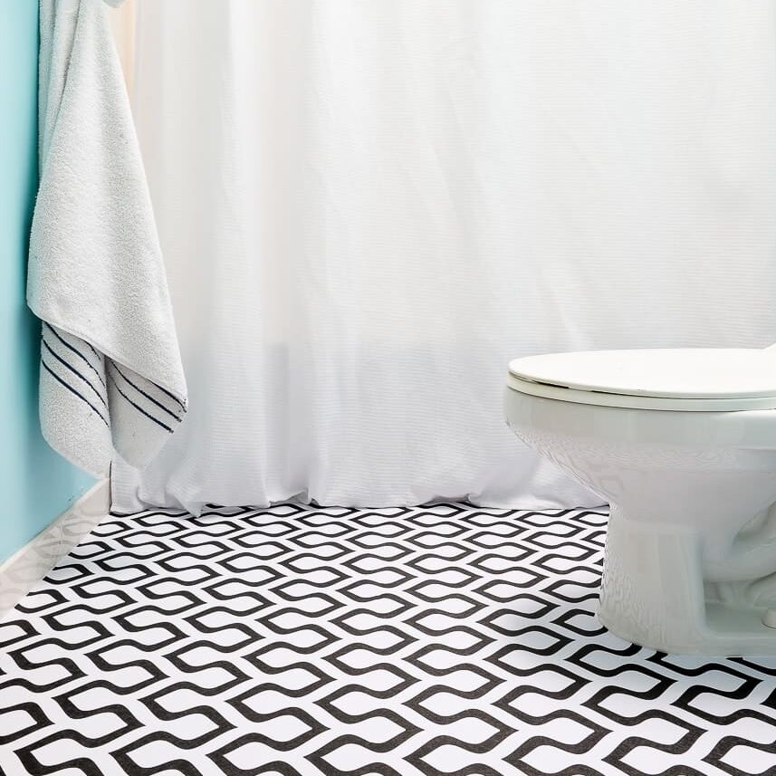 Are you looking for bold DIY home decor ideas? Try putting vinyl wallpaper on your bathroom floor! | The Dating Divas