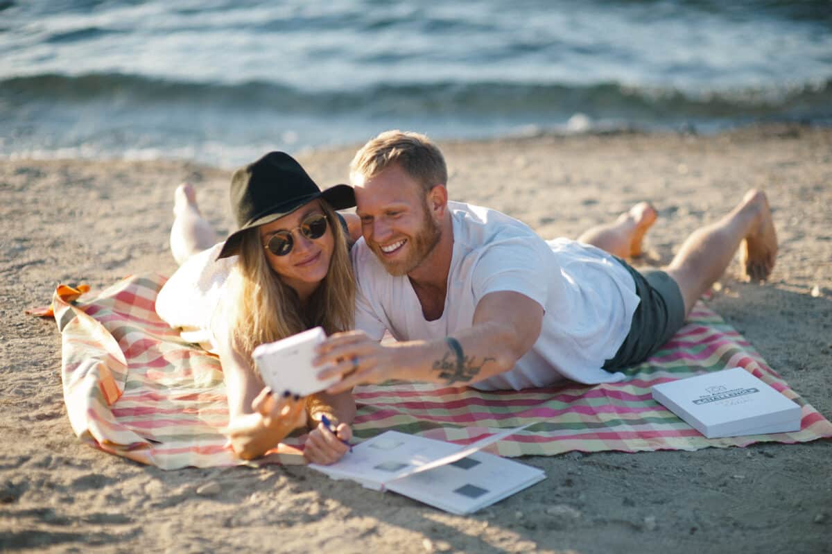 Couple snapping a photo while they complete their date from The Adventure Challenge | The Dating Divas