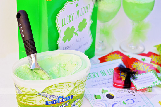 Tub of green ice cream with black handled ice cream scoop